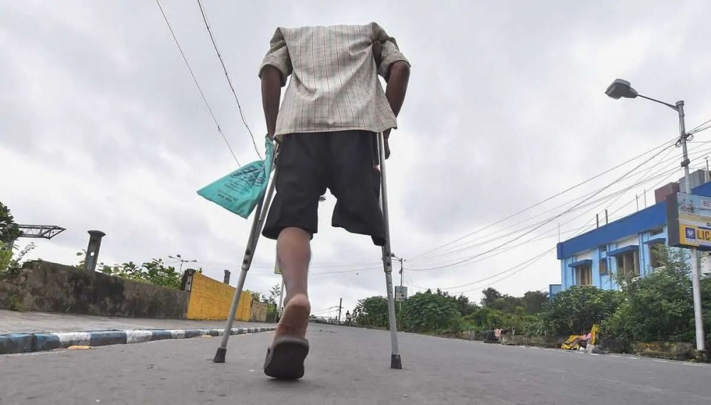 A man with disability walks on a deserted street during the biweekly lockdown in the wake of coronavirus pandemic in Kolkata, Thursday, Aug 27, 2020. (PTI Photo/Swapan Mahapatra)